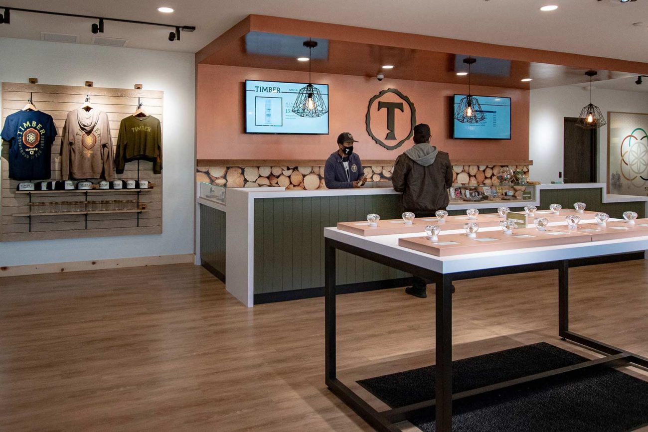 Timber Cannabis Retail Design with employee and customer